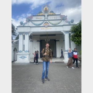 Juan stands in front of the entrance to the palace.